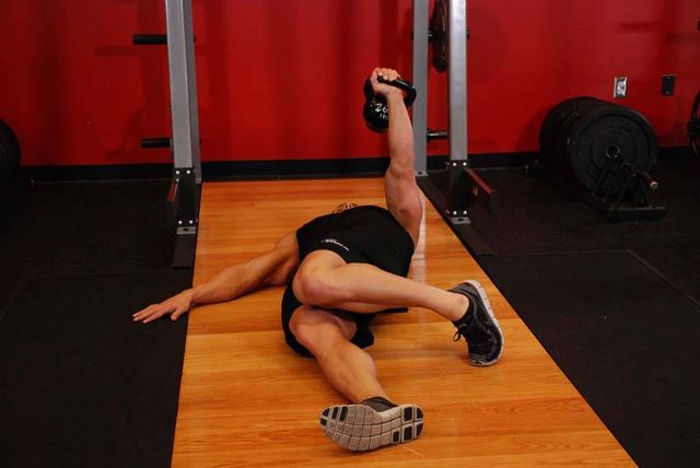 Extended Range One-Arm Kettlebell Floor Press: finishing position