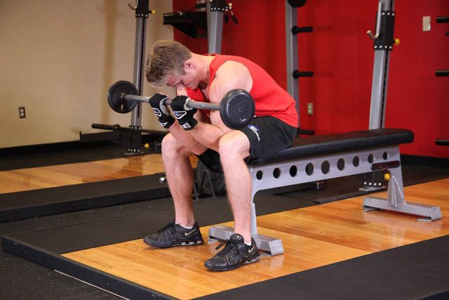 Seated Close-Grip Concentration Barbell Curl: finishing position