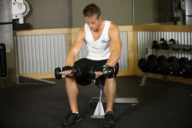 Seated Dumbbell Palms-Down Wrist Curl: finishing position