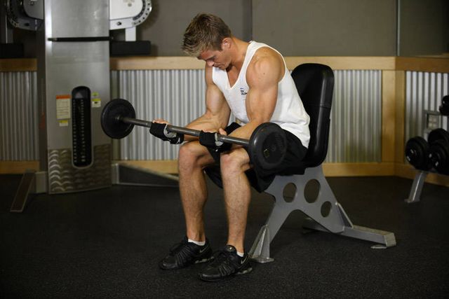 Seated Palm-Up Barbell Wrist Curl: finishing position