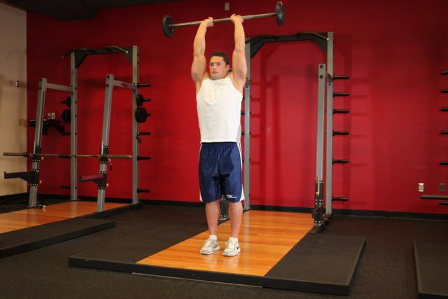 Standing Overhead Barbell Triceps Extension: finishing position